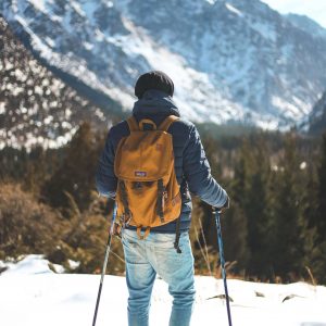 man snowshoeing in Morzine looks out across mountain view