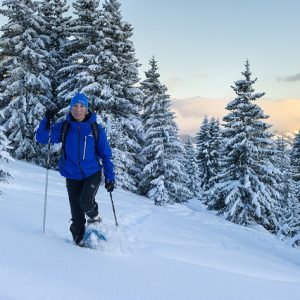 woman snowshoeing on Mont Chery through forest