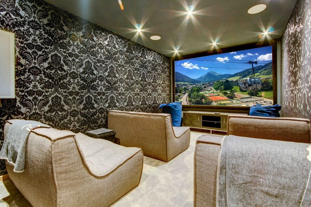 Luxury Cinema room with cosy sofa chairs and a large projector screen
