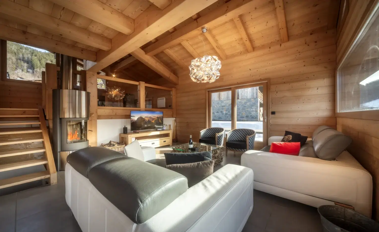 Elevation Alps- Chalet Sunnyside-Open plan living area with log burner